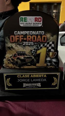 Record Off-Road Series 2025 first-place trophy featuring a trophy cup, a racing helmet, and a race truck, with a base engraved for Class Open winner Jorge Lameda.