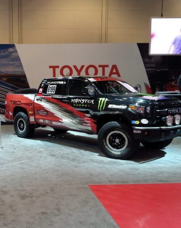 Toyota Tundra TRD Pro race truck with Monster Energy branding on display at an indoor event.